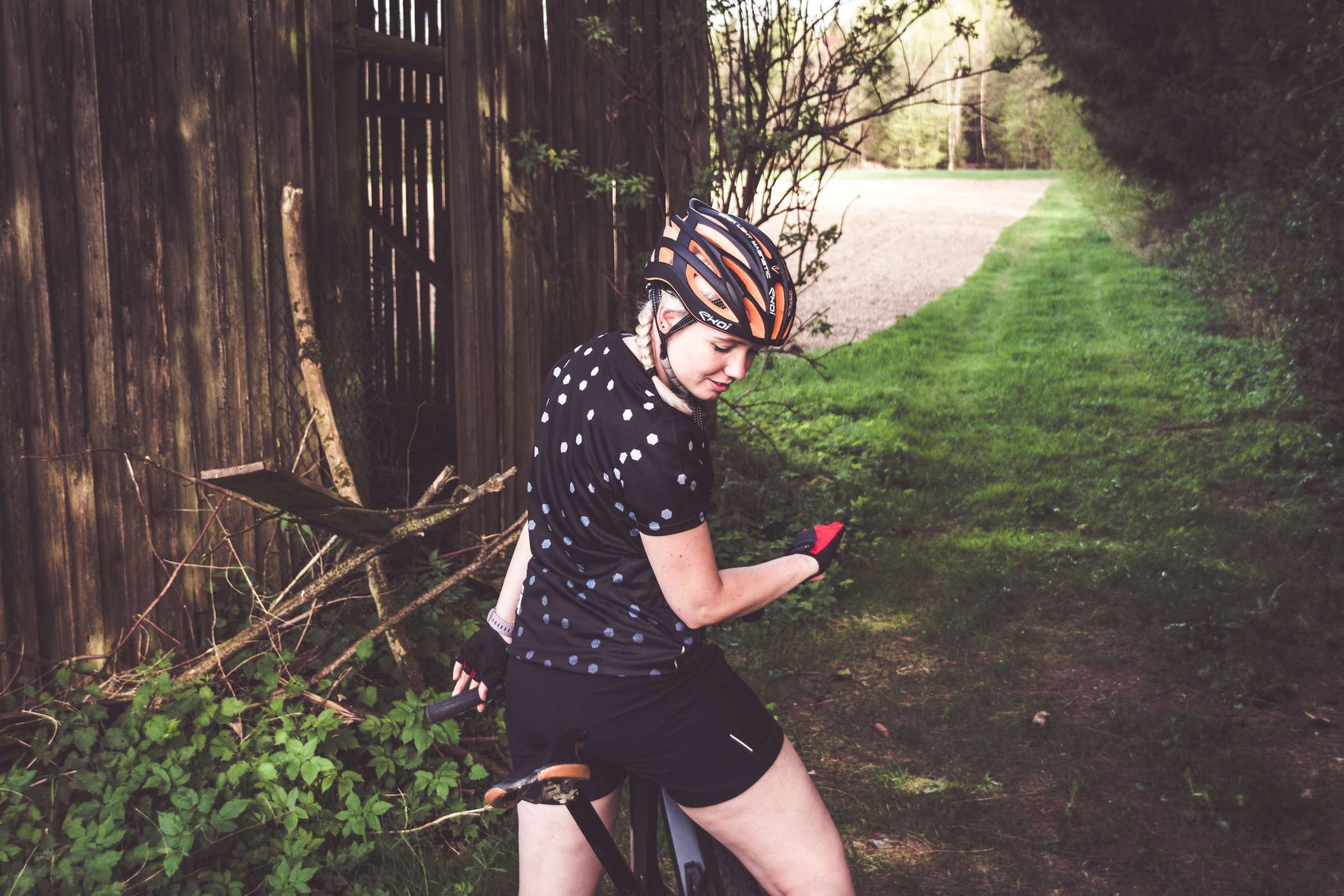 Frau sitzt auf einem Mountainbike und blickt nach unten