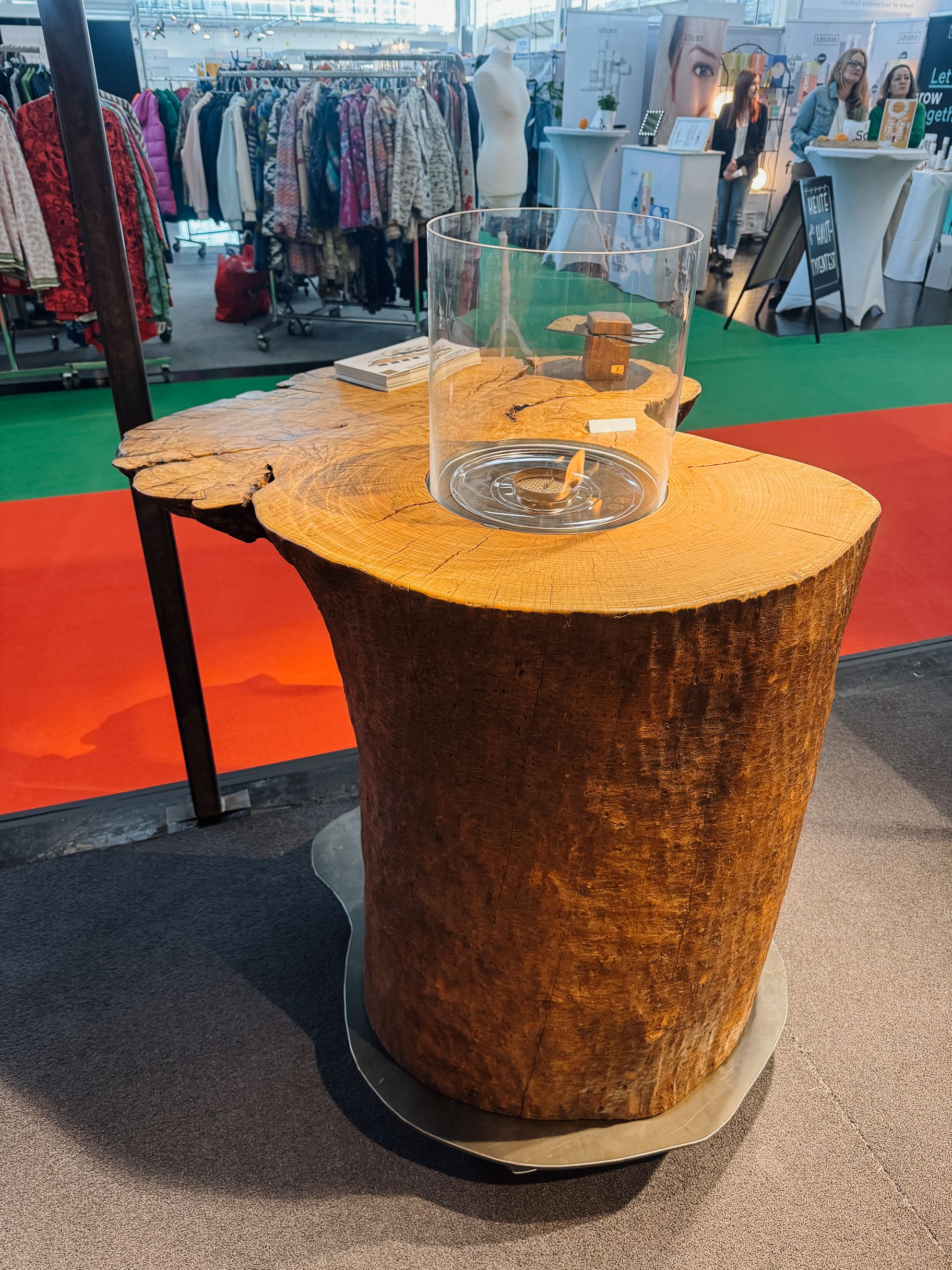 Designer standing table made from an ash tree trunk with live edge and central fire section