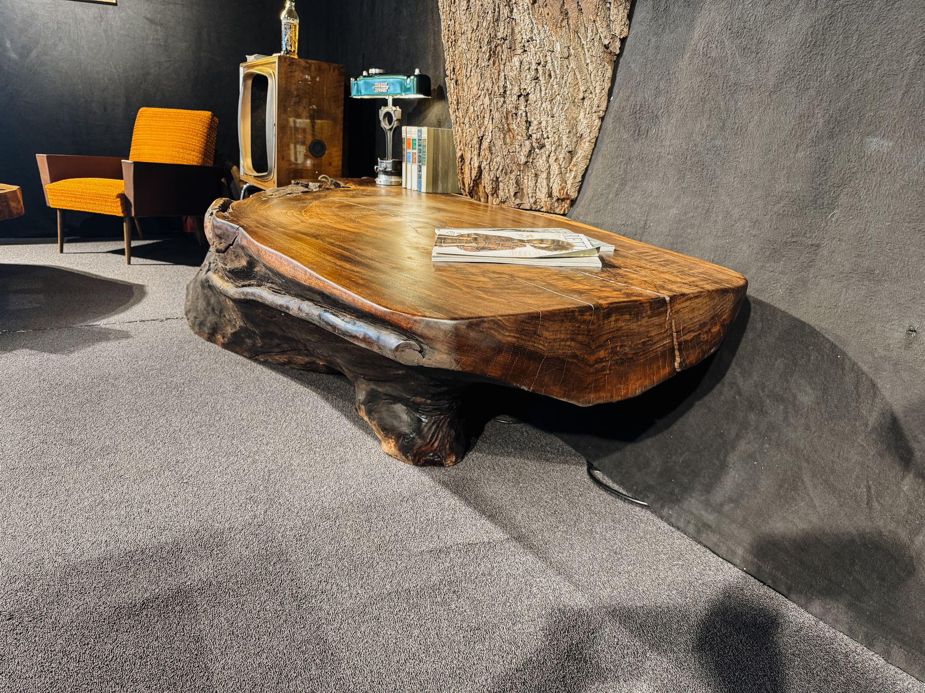 Handcrafted walnut side table made from a solid tree trunk with a striking live edge