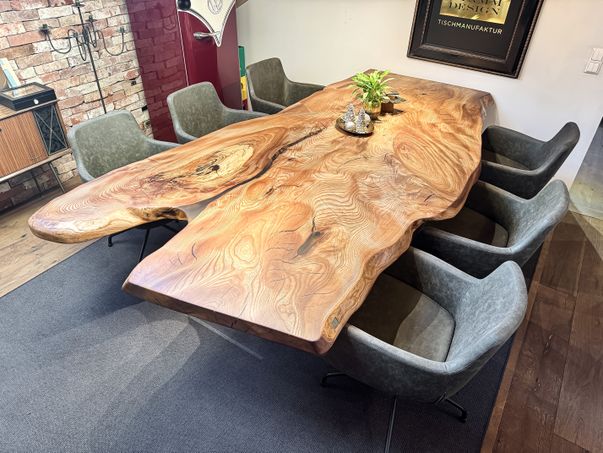 Elm slab dining table with striking grain and clear glass legs handcrafted at Stammdesign