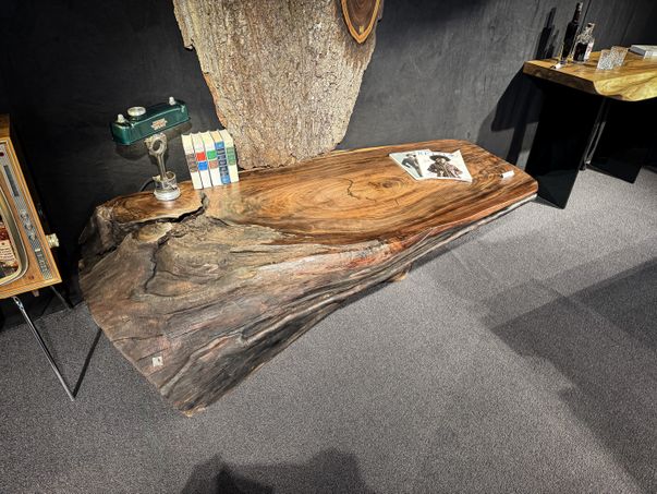 Side table made from a whole walnut trunk with natural live edge and distinctive grain