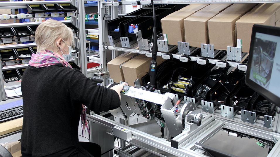 Employee assembles at a LEAN workstation