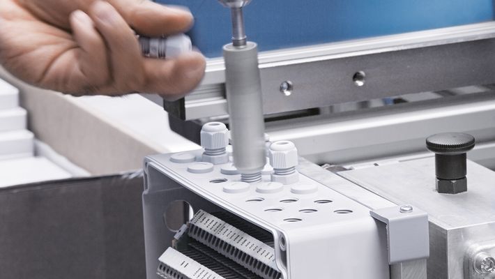 Mounting cable glands on an enclosure