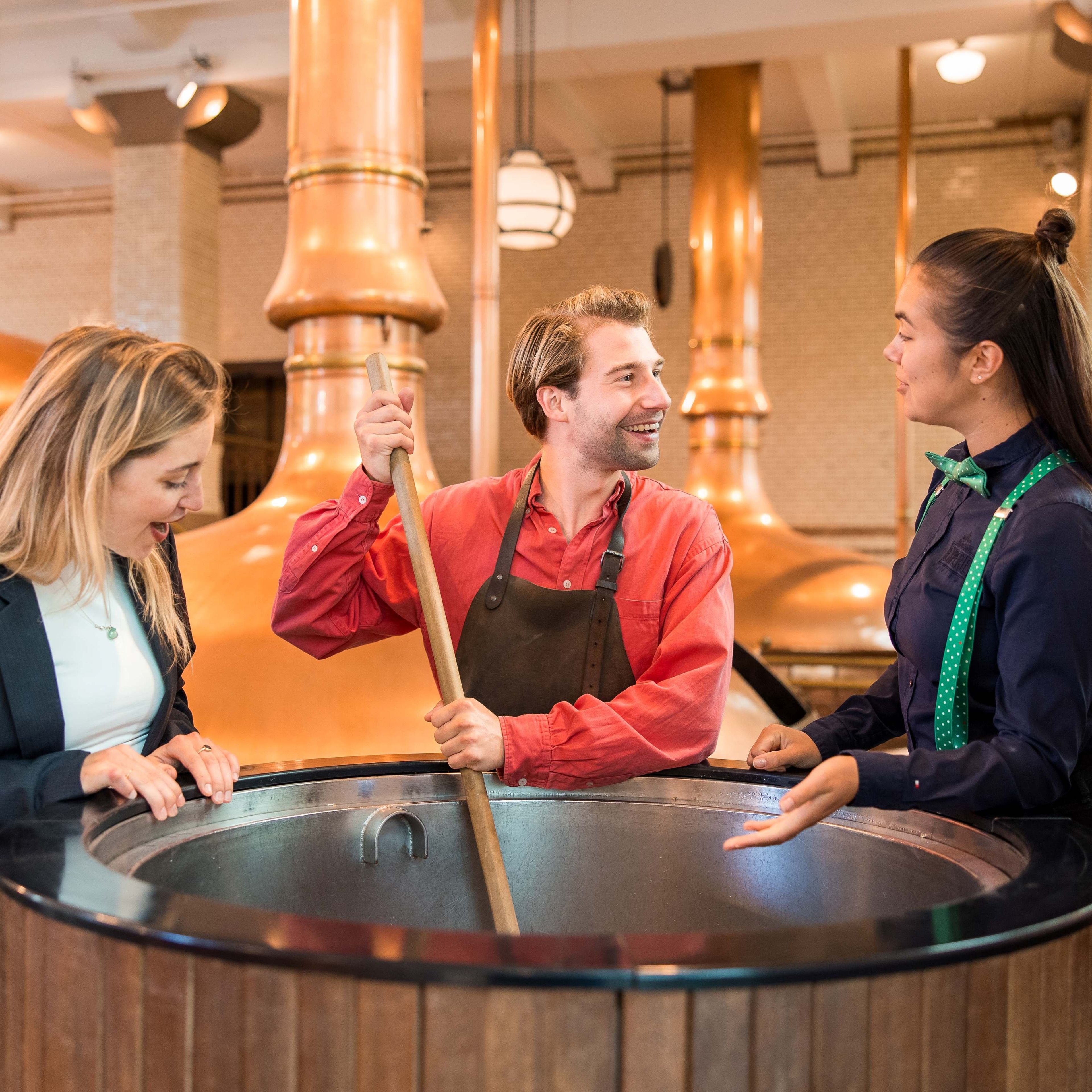 Visitors learning about beer brewing at the Heineken Experience in Amsterdam.
