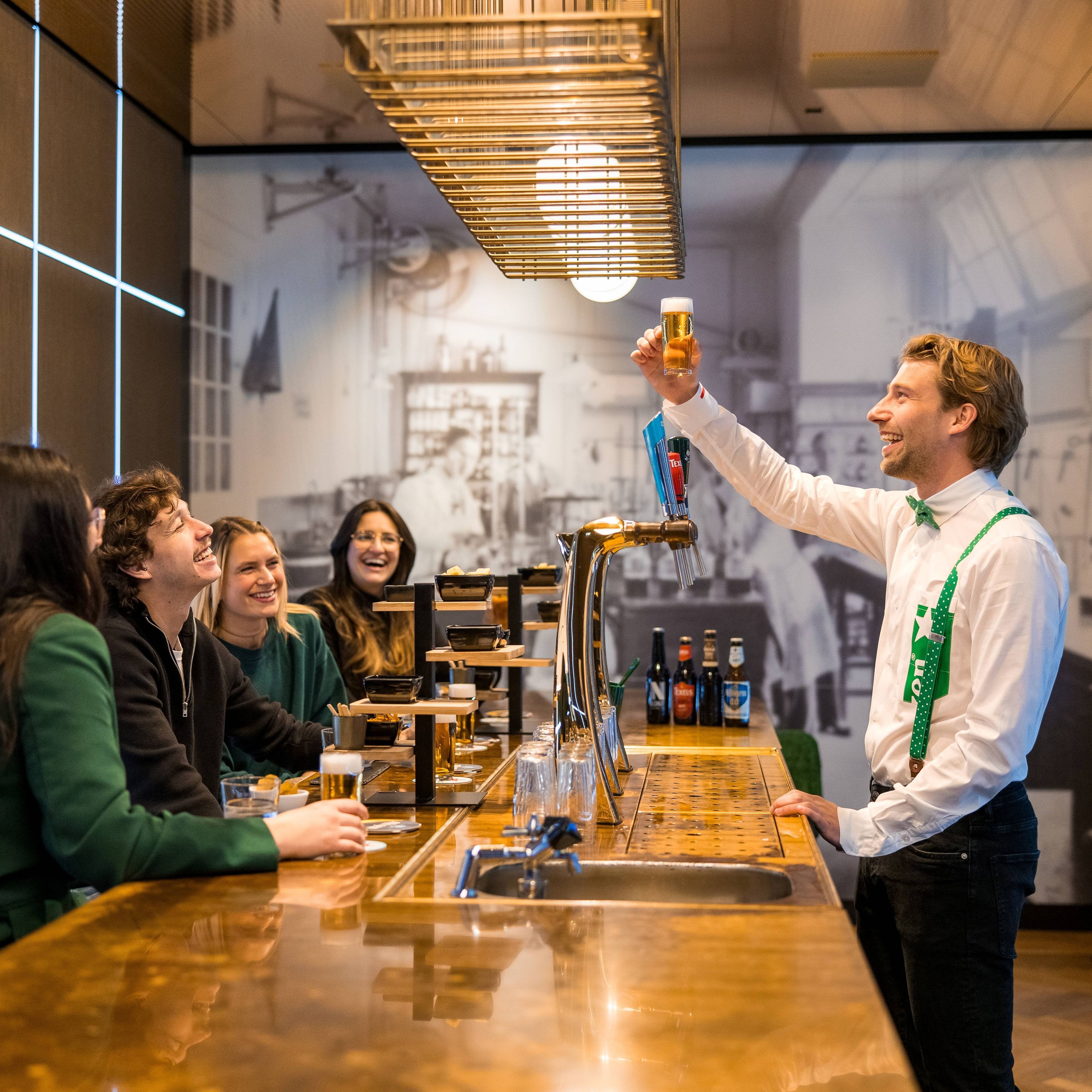 A group of people enjoying a beer tasting experience at a stylish bar.