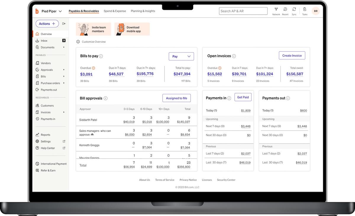 Laptop displaying a financial dashboard with bills to pay, open invoices, and payment tracking.