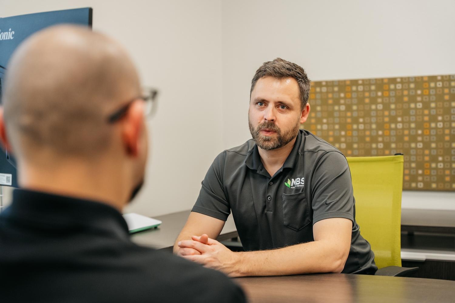 CJ and Riccardo from the MBS Accountancy team in discussion at a desk.