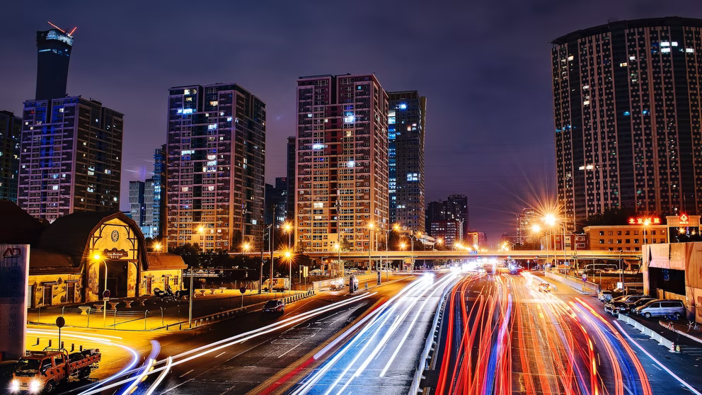 A long exposure image of a busy street at dust — the car headlights are blurred lines.