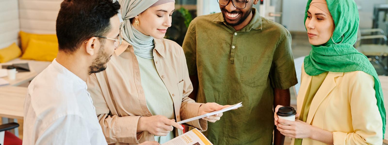 A group of colleagues huddled and happy