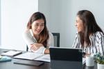 A young accountant is in a business meeting with their new client.