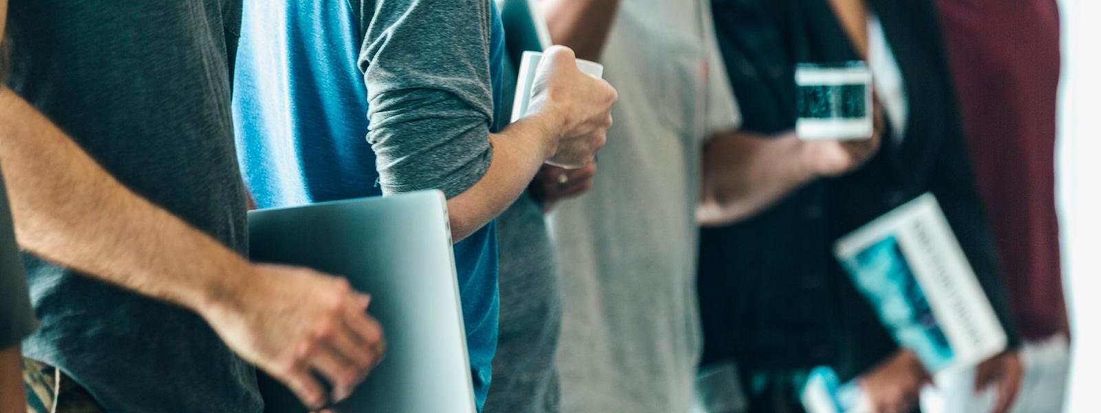 A line of young adults standing at work