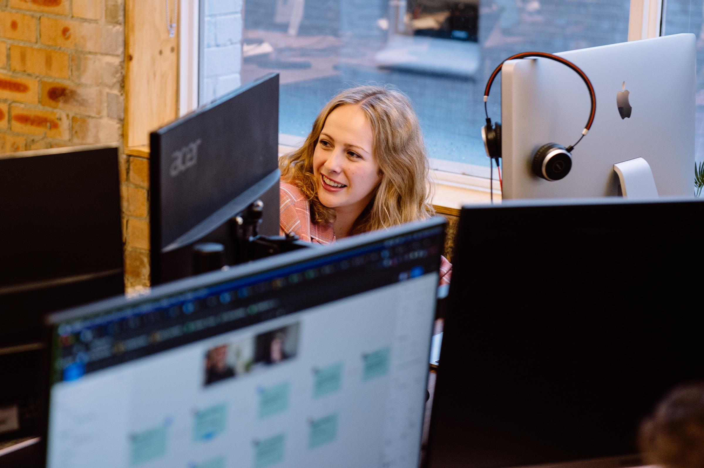 Amelia, Product Manager, mid-discussion at her desck at the Karbon offices in Sydney.