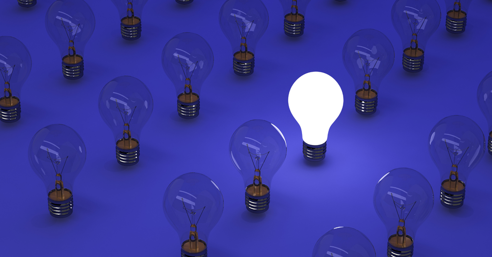 Several light bulbs that are unlit, only one light bulb is one, indicating ideas.