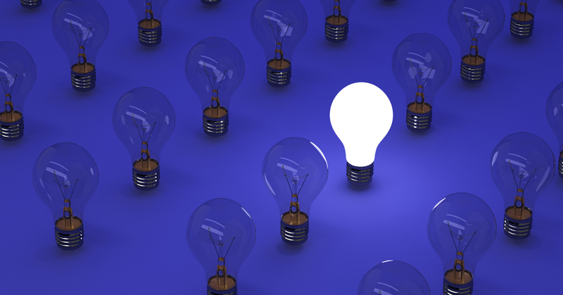 Several light bulbs that are unlit, only one light bulb is one, indicating ideas.