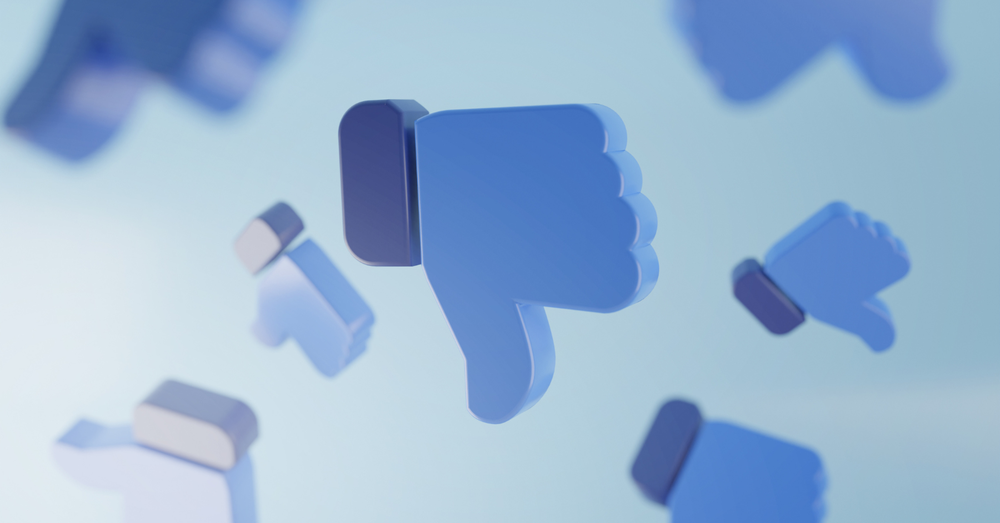 Floating 3D blue thumbs-down icons on a light blue background, indicating disapproval or dislike.