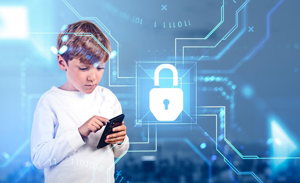 Boy in casual wear standing holding smartphone near digital interface with padlock and binary code with cityscape in background