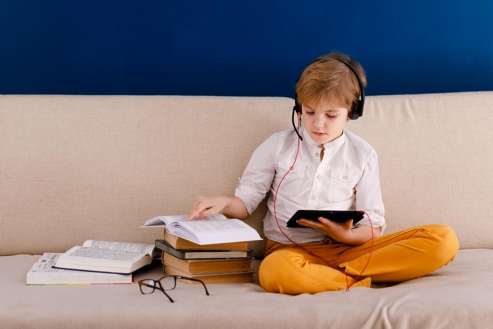 Boy using digital tablet for his homework, for searching information on internet