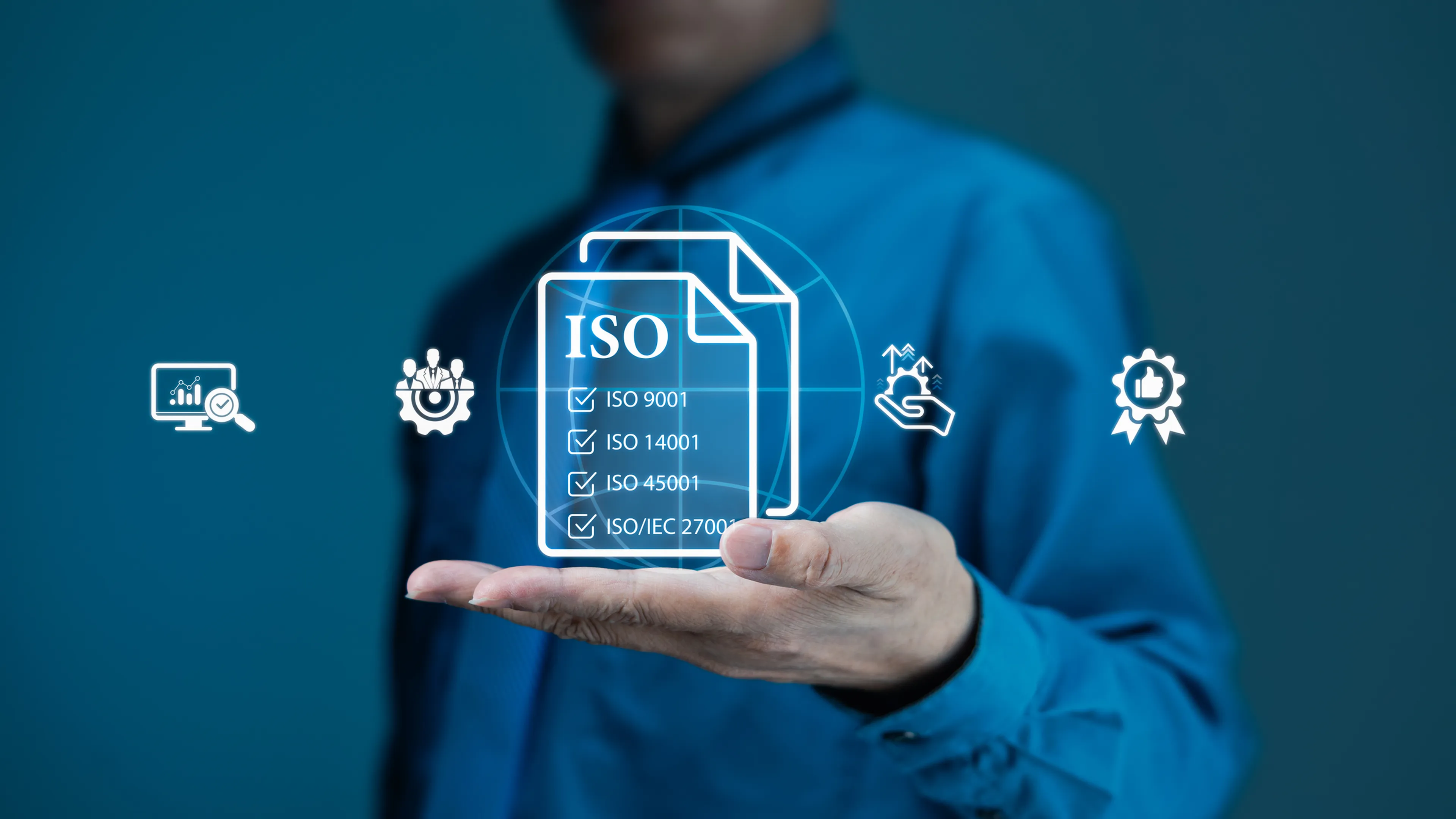 Person in blue shirt holding digital ISO certification hologram with check marks, surrounded by technology and quality icons on a blue background.