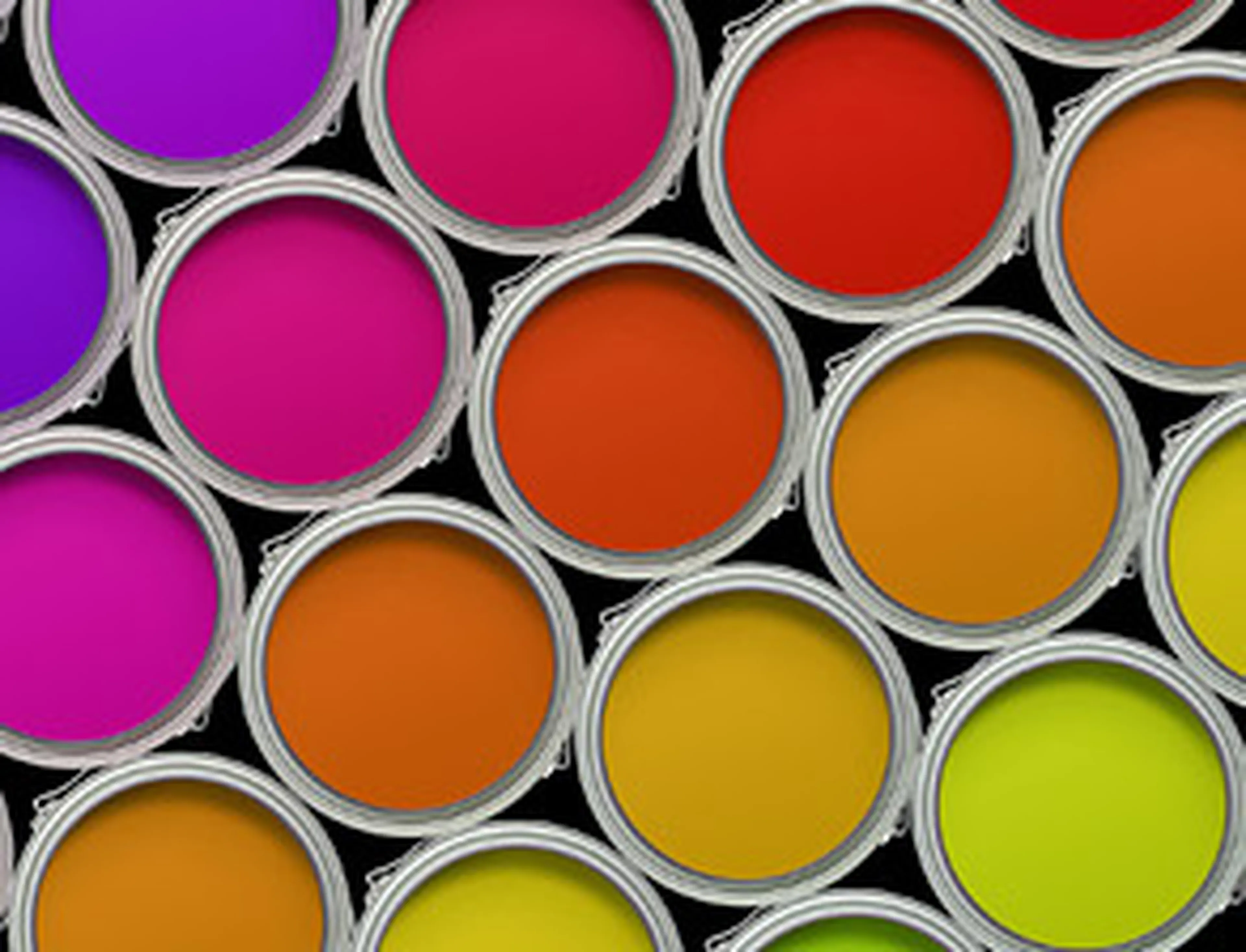 Open paint cans in bright colors, including purple, pink, red, orange, yellow, and lime green, arranged closely together on a black background.