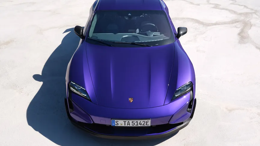 The Taycan Turbo GT with Weissach Package, from an aerial view, parked in a wide-open landscape area.