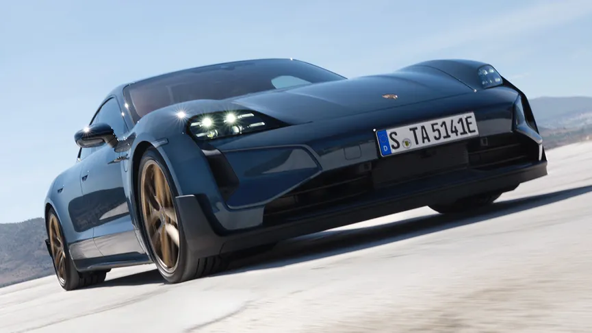 The Taycan Turbo GT stationary in a wide-open landscape area.