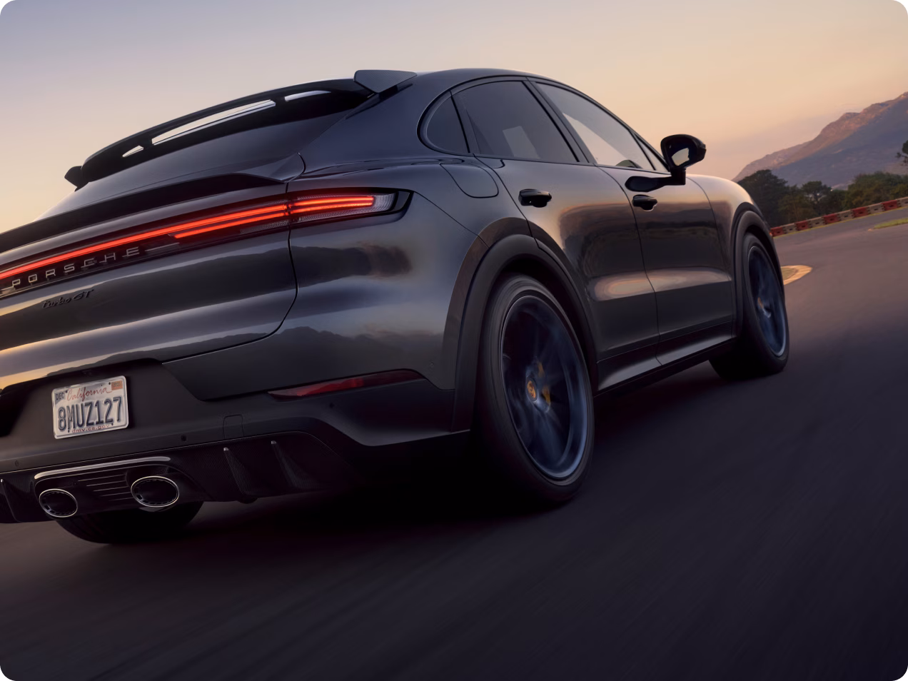 Porsche Cayenne Turbo GT in Quartzite Gray Metallic driving on the circuit. Top view of rear end and side.