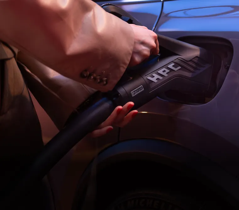 Porsche Macan 4 in Provence charging. Side visible.