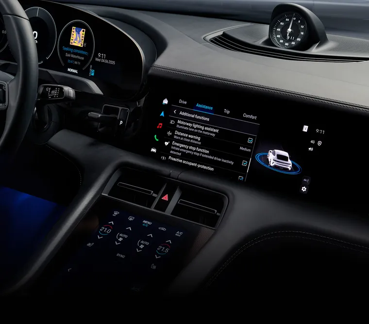 View into the cabin of the Porsche Taycan 4S Black Edition. The infotainment system screen shows the assistance systems.