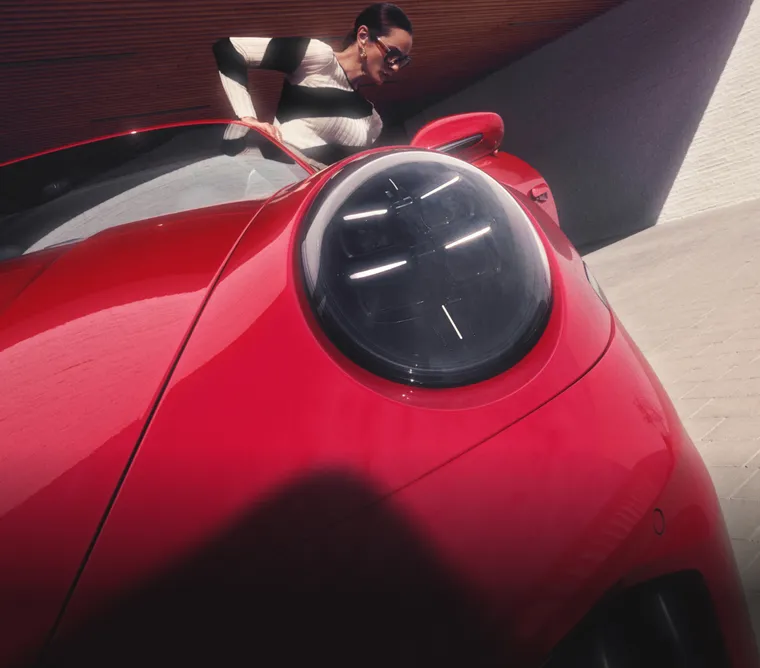 Porsche 911 Targa 4 GTS in Carmine Red. Detailed view of a Matrix LED main headlight.