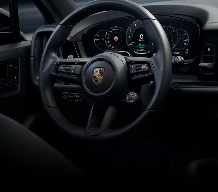 Detailed view of the GT sports steering wheel on the Porsche Cayenne Black Edition.