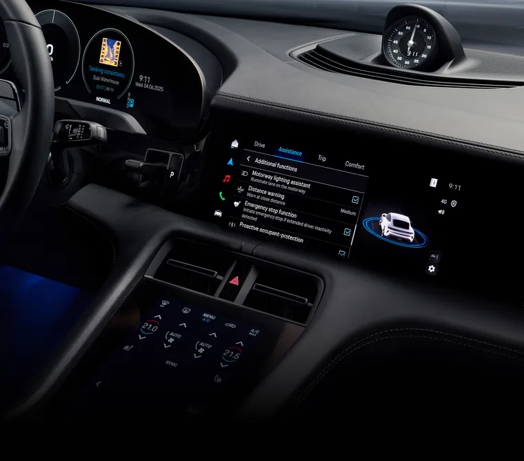 View into the cabin of the Porsche Taycan 4S Black Edition. The infotainment system screen shows the assistance systems.