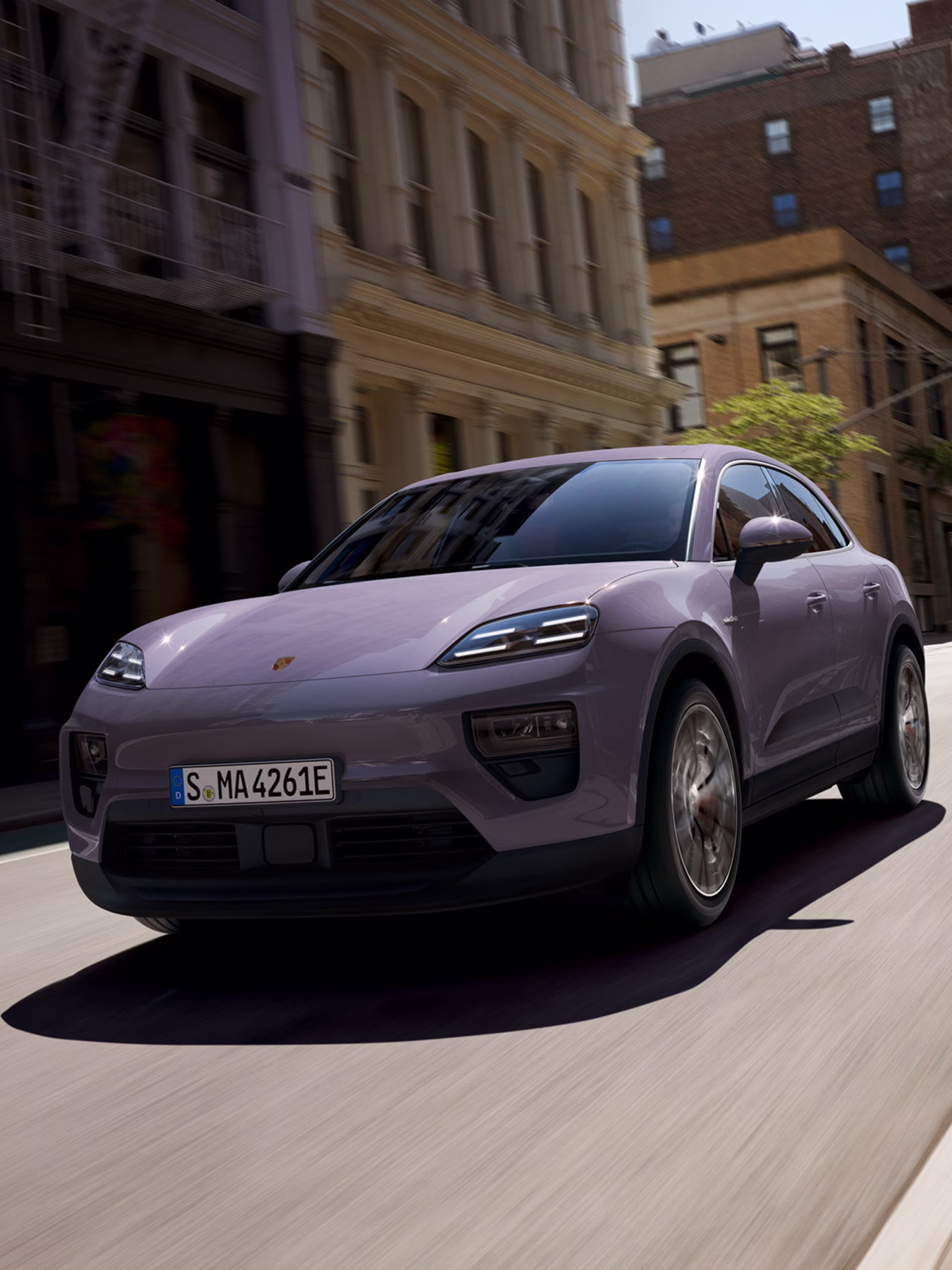 The Macan Electric driving along a road.