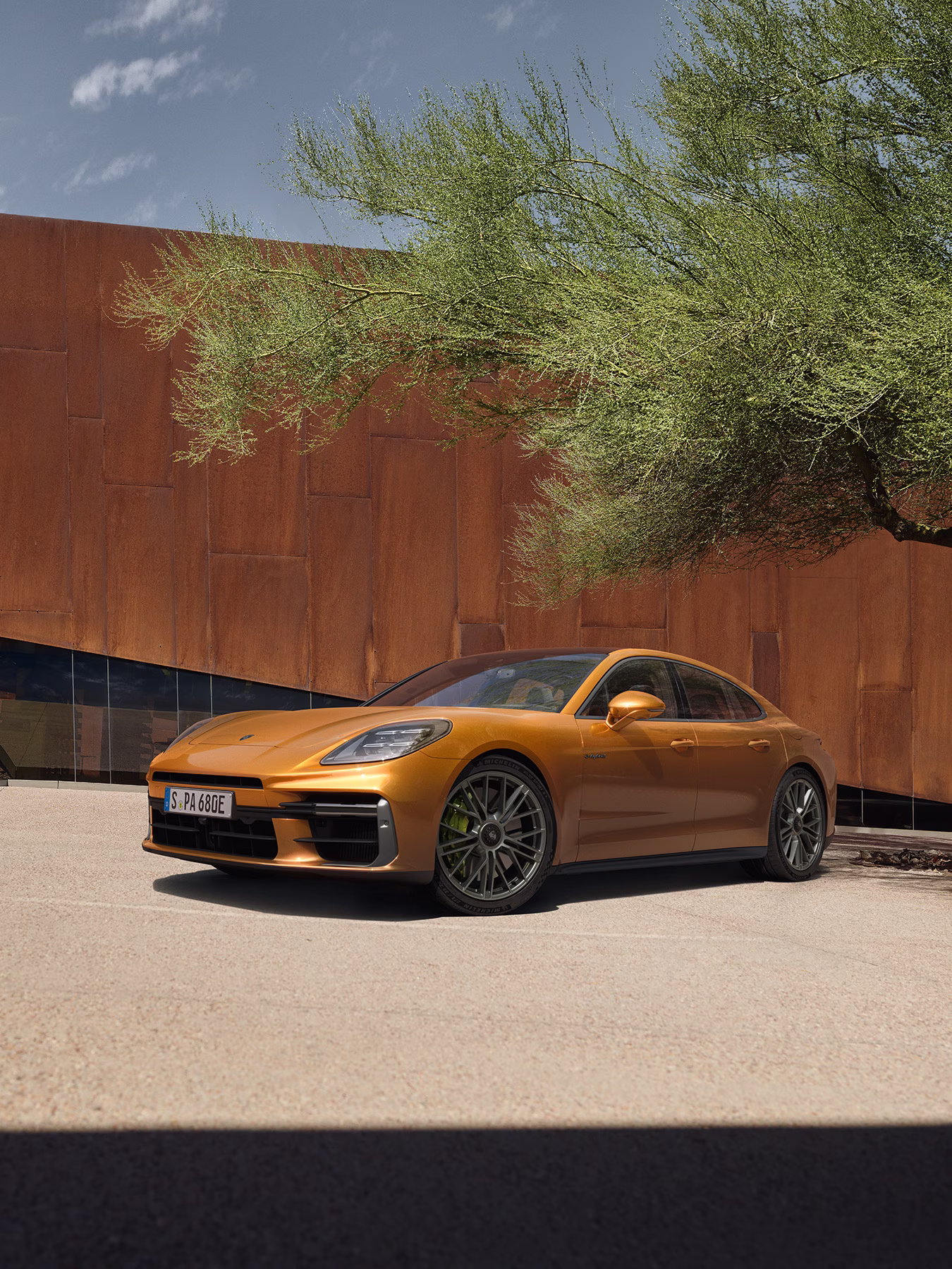Panamera Turbo E-Hybrid under a tree in an urban environment.