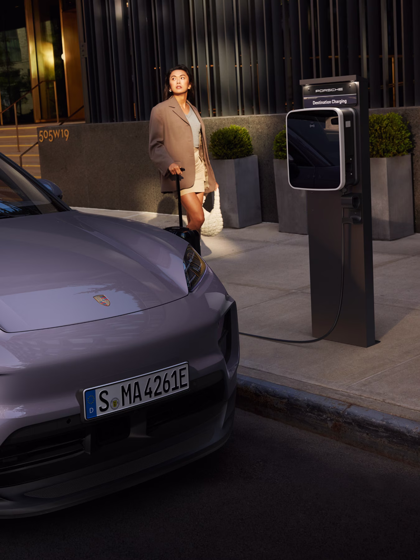 A Macan Electric being charged using a Porsche Destination Charging unit.