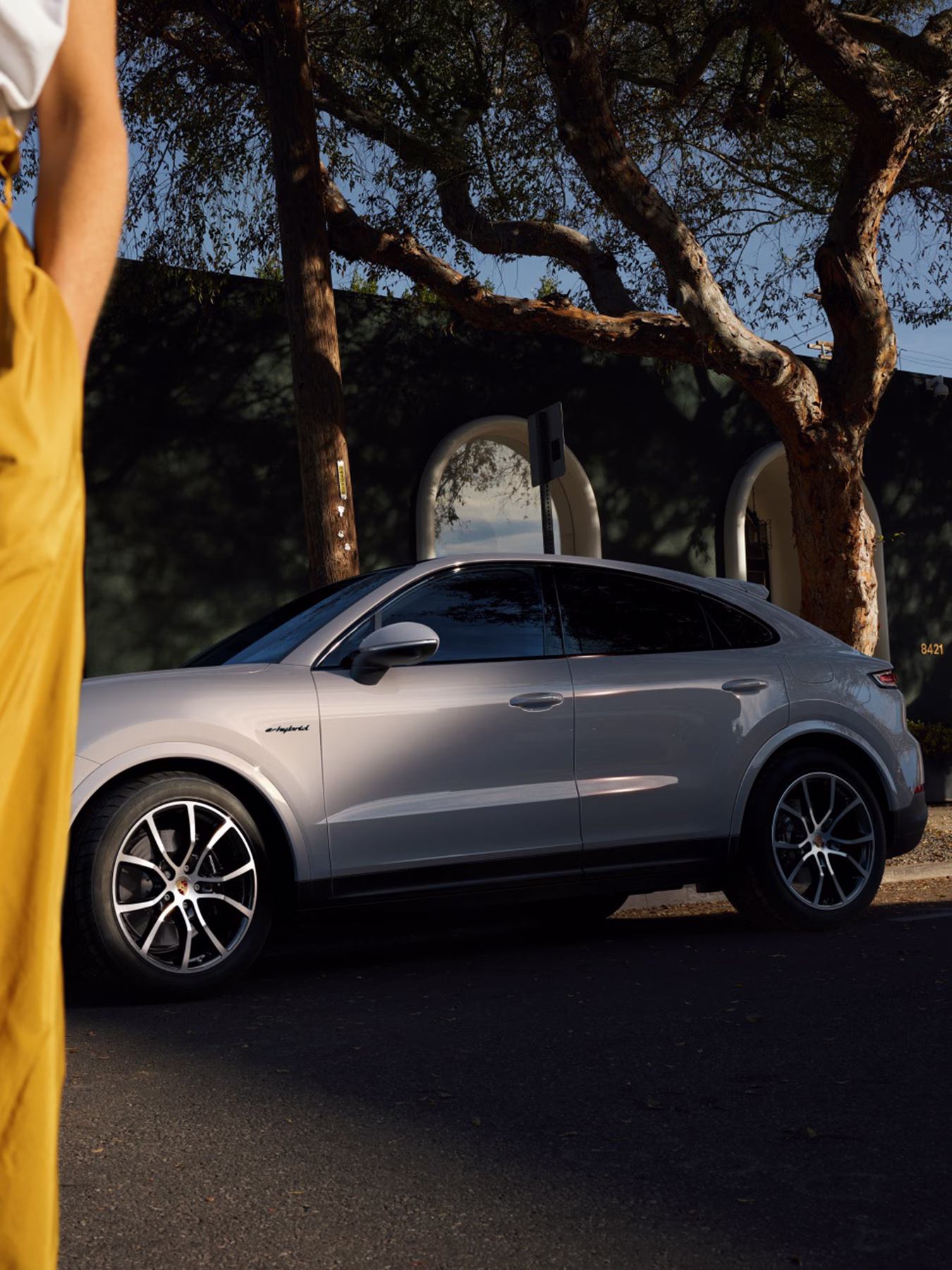 Cayenne E-Hybrid Coupe parked outside with a  women in front