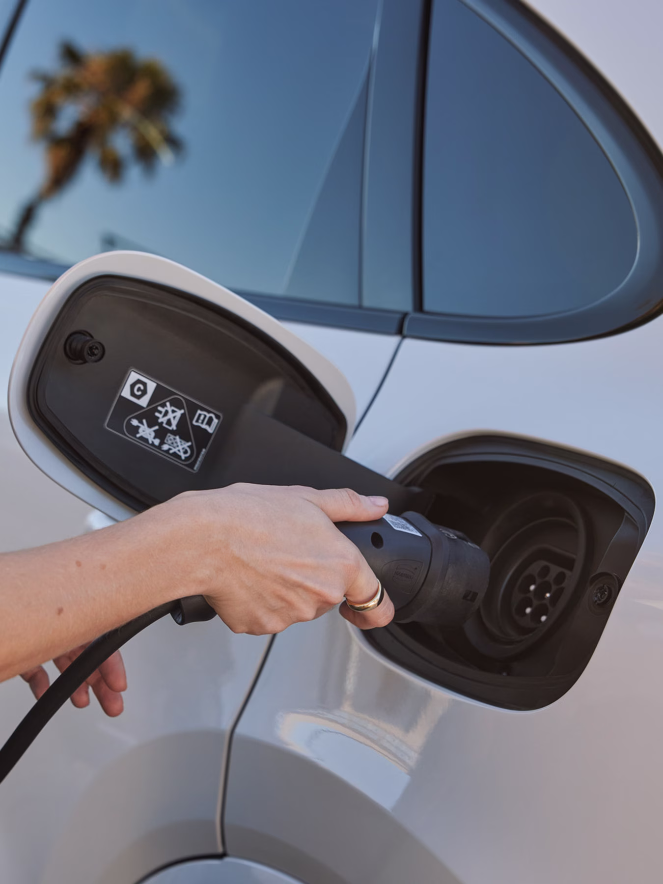 A Taycan Turbo S Sport being charged using a wall charger at home.