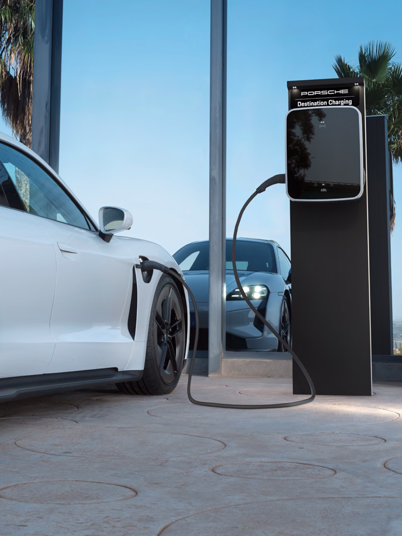 A Taycan being charged using a Porsche Destination Charging unit.