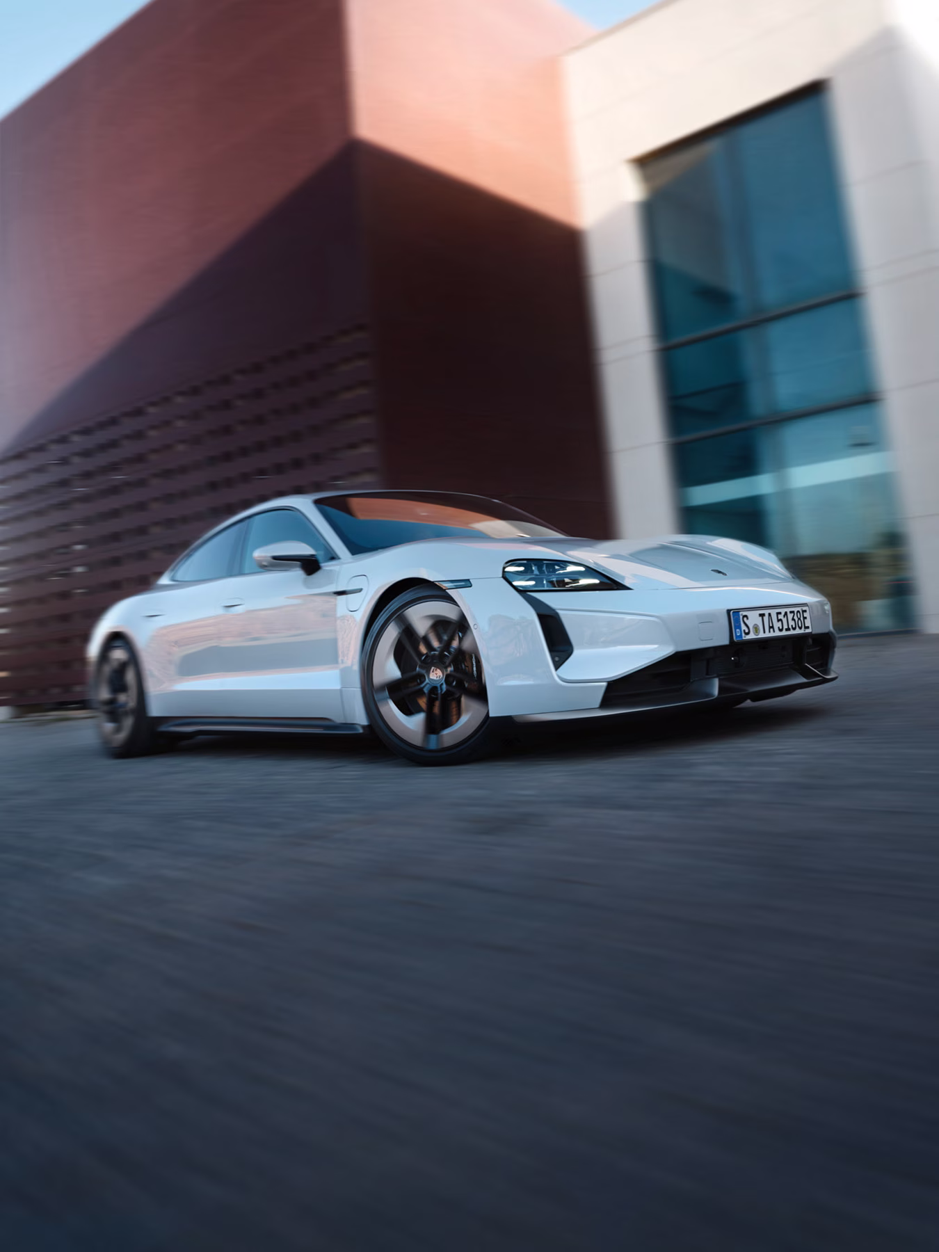 The Taycan Turbo S Sport driving along a road.