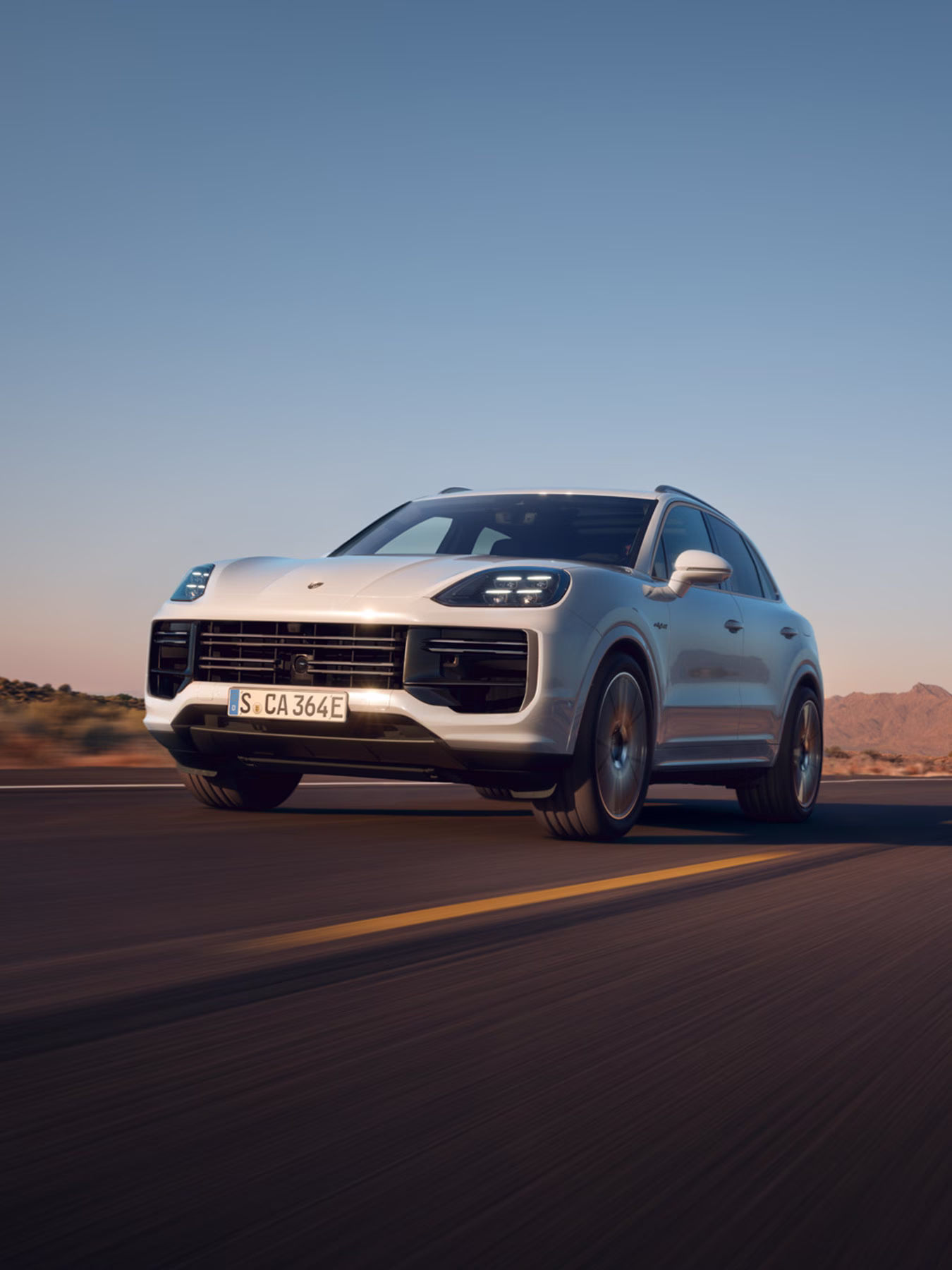 The Taycan Turbo S Sport driving along a road.