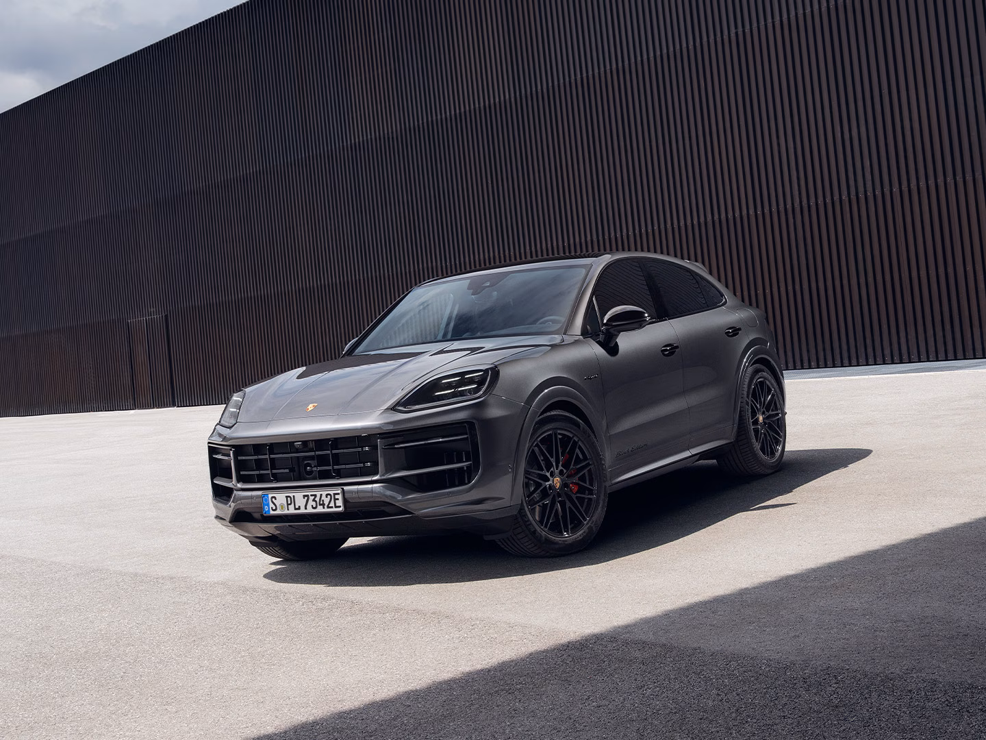 The Cayenne S E-Hybrid Coupé Black Edition parked up in a contemporary, modern environment.