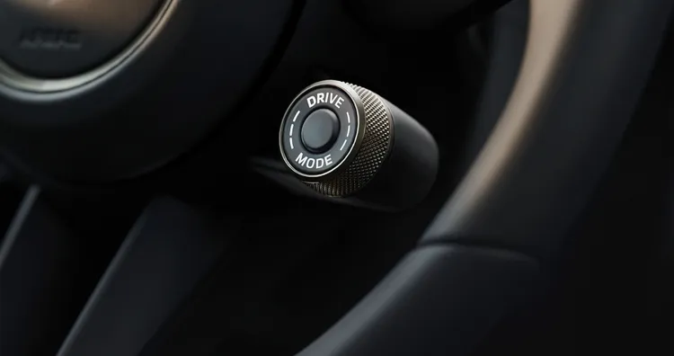 Detailed view of the mode switch on the steering wheel of the Porsche Panamera Turbo E-Hybrid.