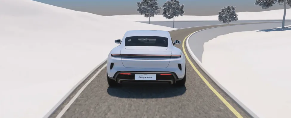 View of the rear of a moving Porsche Taycan.