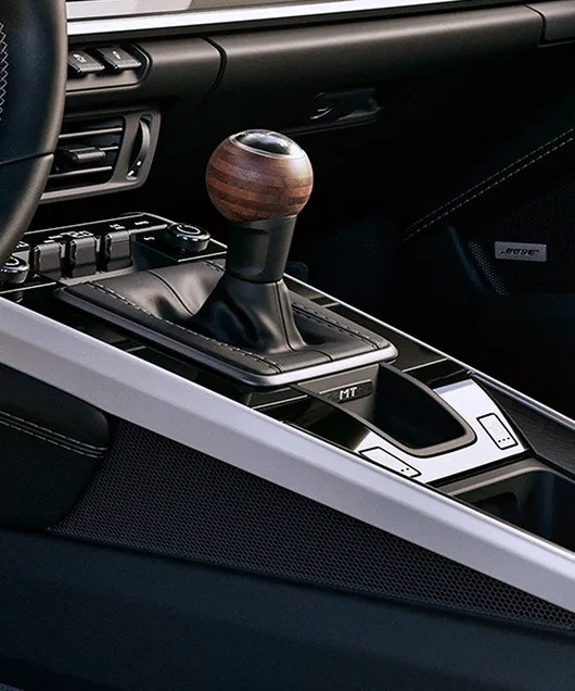 close-up from manual transmission with engraved “MT” badge.