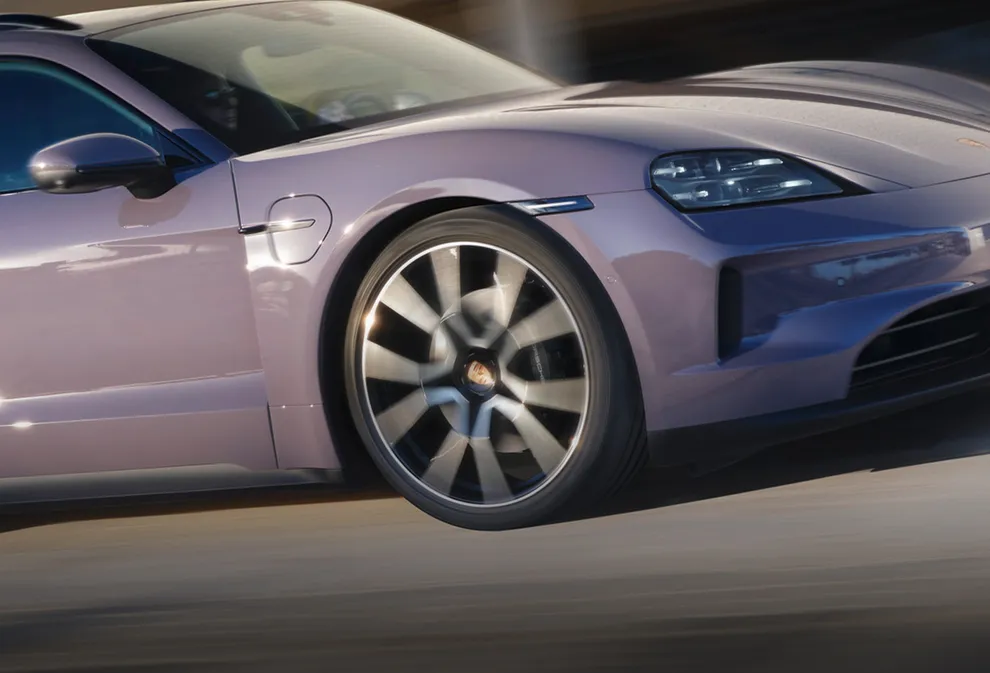 Porsche Taycan 4S Sport Turismo in Provence illuminated against a dark background. Front and side views.