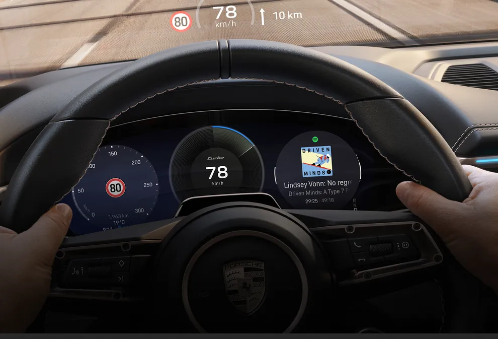 Porsche Macan Turbo interior. View of the Advanced Cockpit and the augmented reality head-up display during a journey.