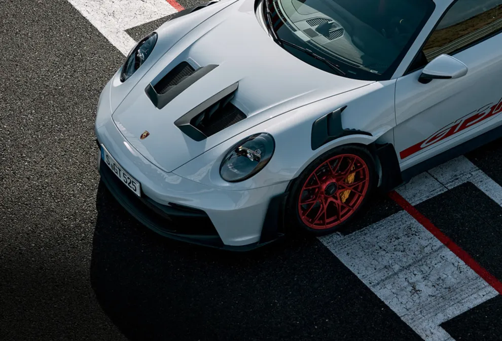 The Porsche 911 GT3 RS in Ice Grey Metallic on a race track. Top view of the bonnet.