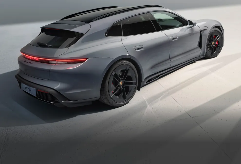 View of the rear and side of the Porsche Taycan GTS Sport Turismo in Slate Grey Neo.