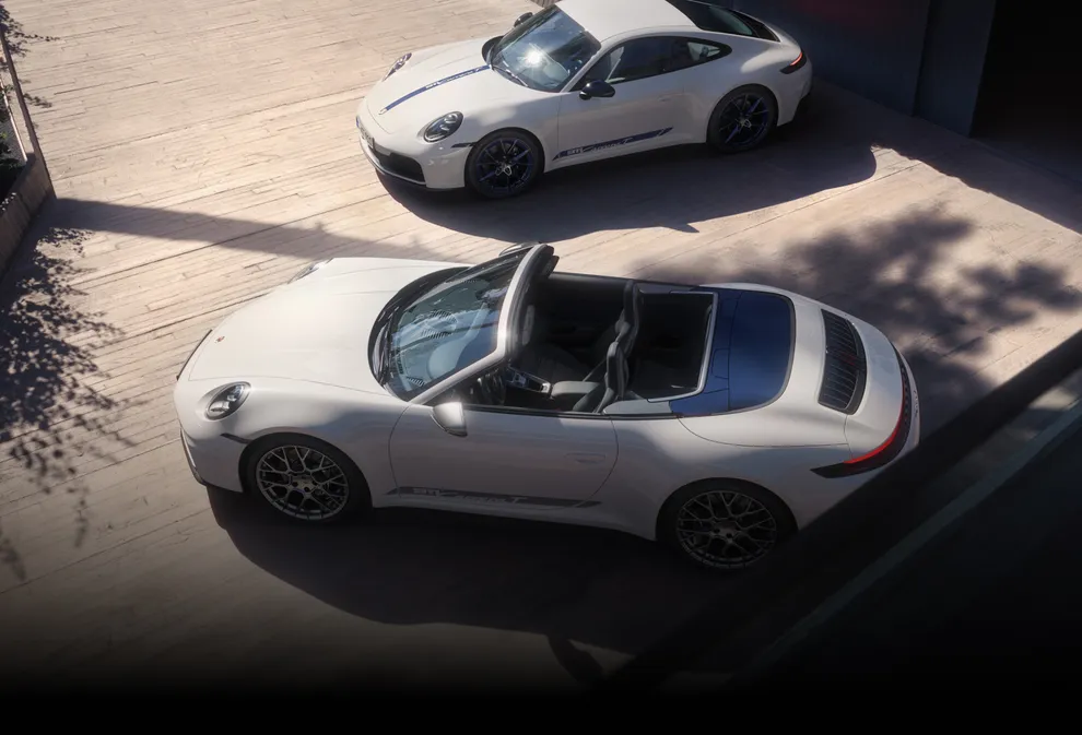 A Porsche 911 Carrera T and a Porsche 911 Carrera T Cabriolet (both in White) stand next to each other.