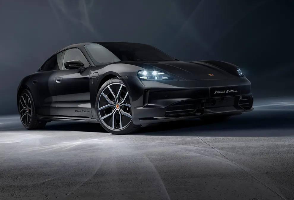 View from the front showing the front and side of a Porsche Taycan 4S Black Edition in Jet Black Metallic.