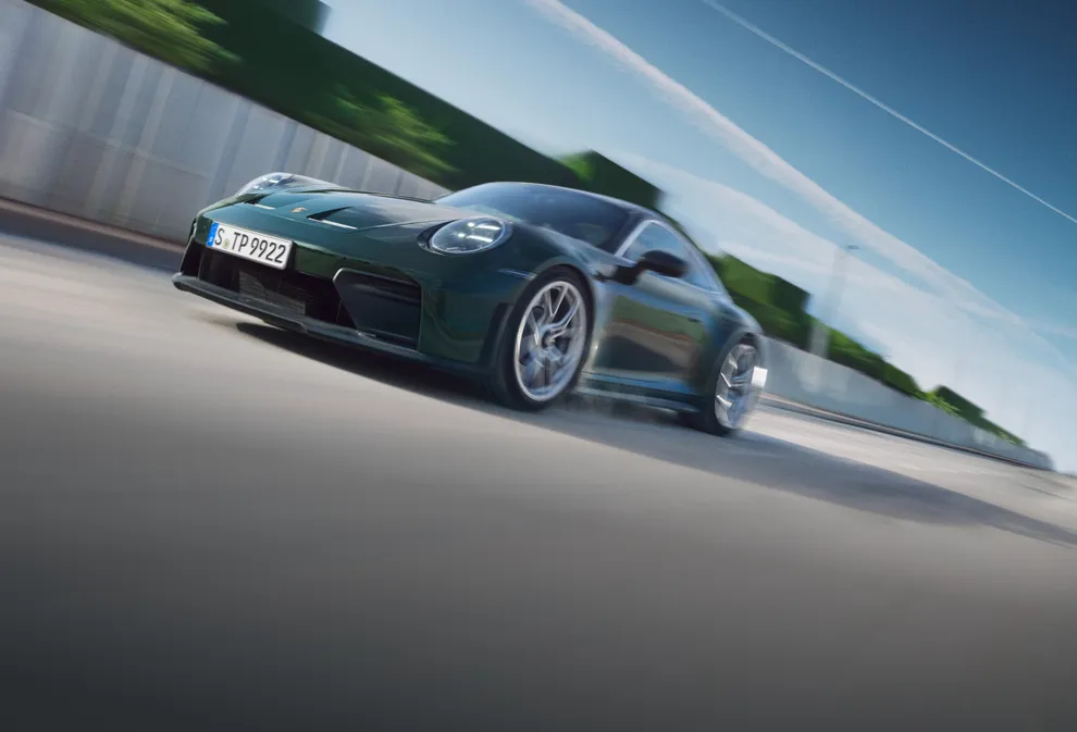 Front view of the front and side of the Porsche 911 GT3 with Touring package in Oak Green Metallic Neo.